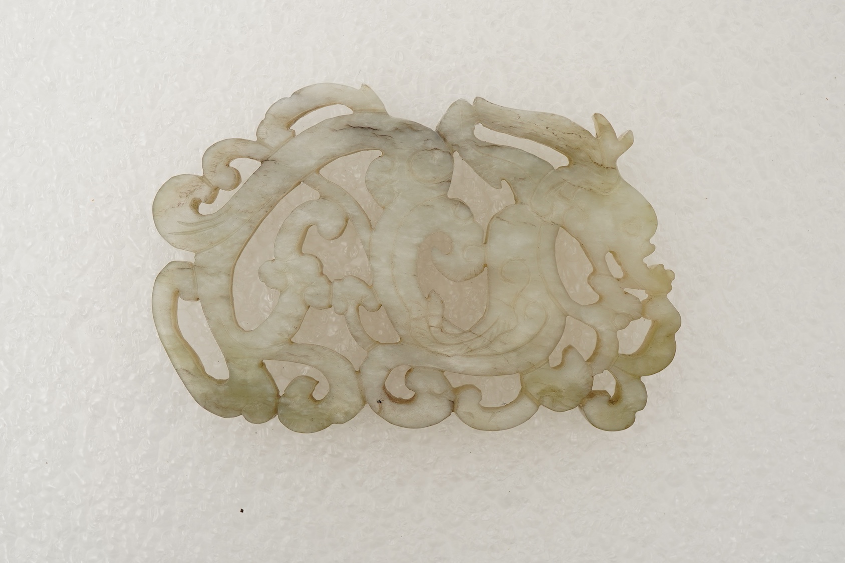 A Chinese white and grey mottled jade ‘chilong’ plaque, Ming dynasty